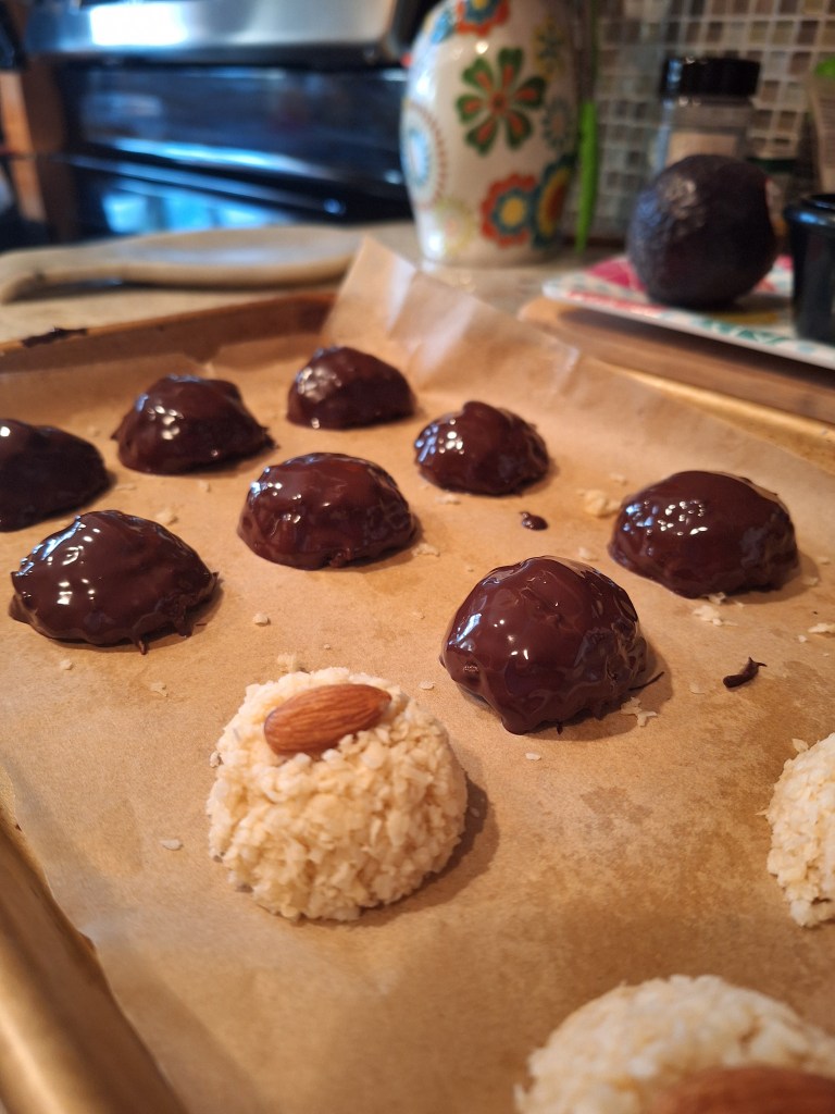 sheet tray of prepared coconut almond dipped in chocolate bites